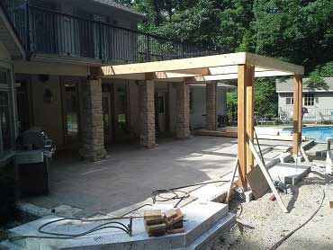 Landscape construction photo of the cedar pergola posts and rafters